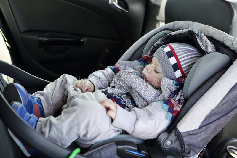 Child sleeping in car seat stock image. Image of interior 114491975