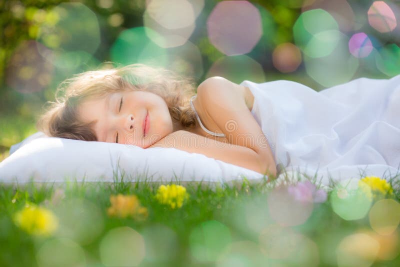 Child sleeping in spring garden