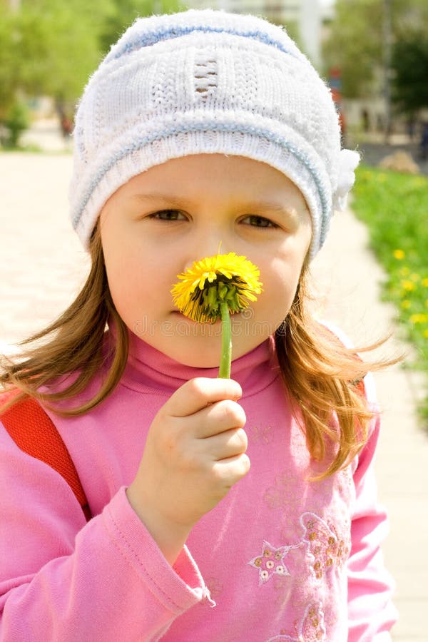 Child smells dandelion