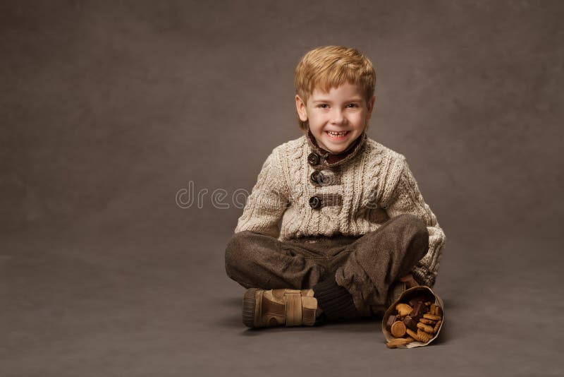 Child smiling in knitted sweater. Boy fashion in retro style. br