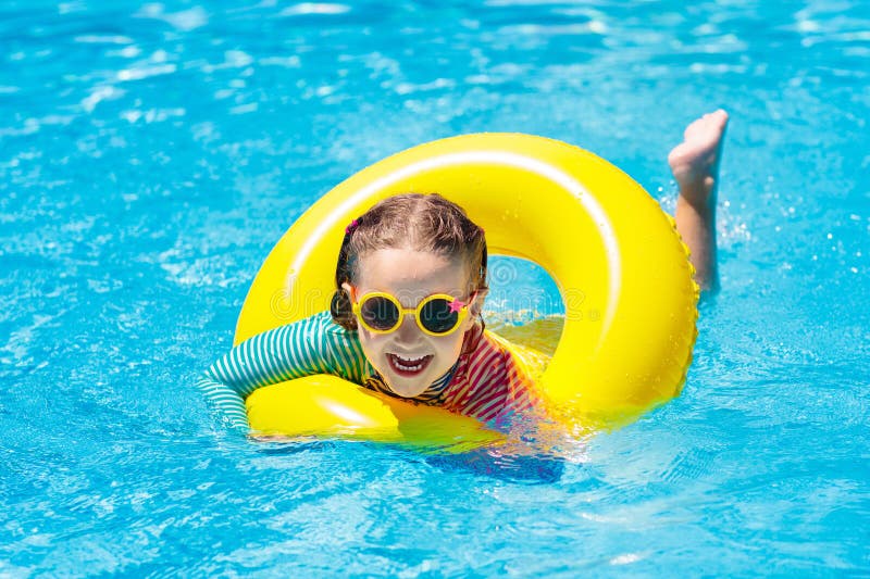 Child in swimming pool. Kids swim. Water play.