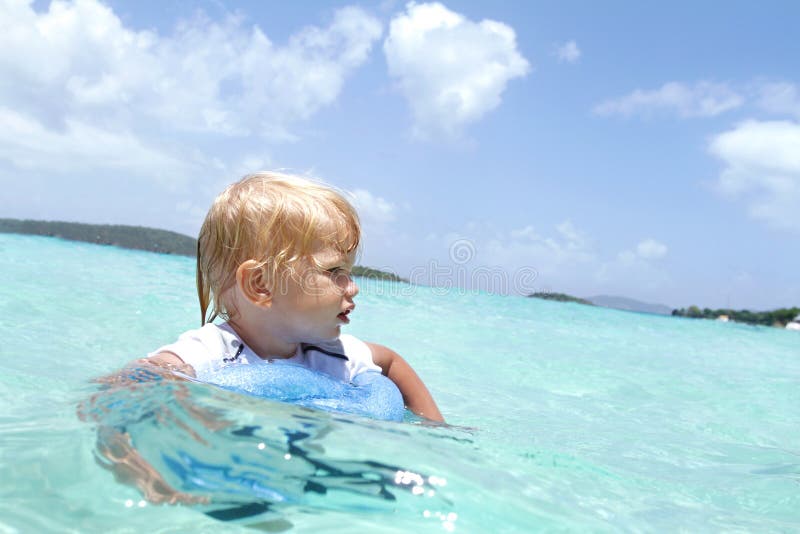 Child Swimming in Tropical Ocean stock photos Child Swimming in Tropical Ocean stock photos