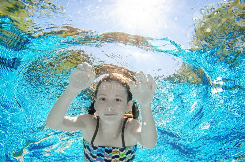 Child Swims Underwater in Swimming Pool, Happy Active Teenager Girl ...