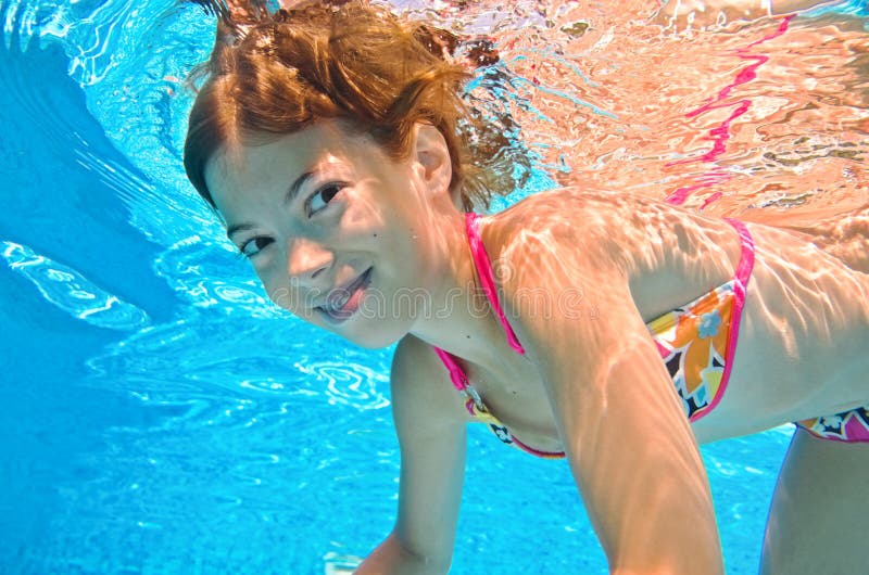 Children Swim In Swimming Pool Underwater, Little Active 