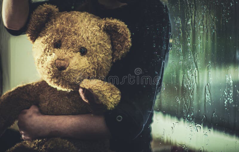Child With Teddy Bear Sitting On Windowsill At Night