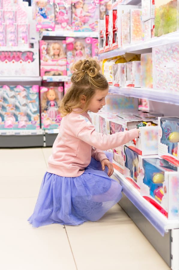 Child in Toy Store. Little Girl in Toy Store Looking Toys Stock Photo ...