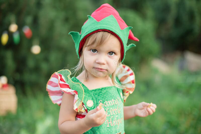 Child waiting for a Christmas in wood in juli. portrait of little children near christmas tree. girl decorating christmas tree