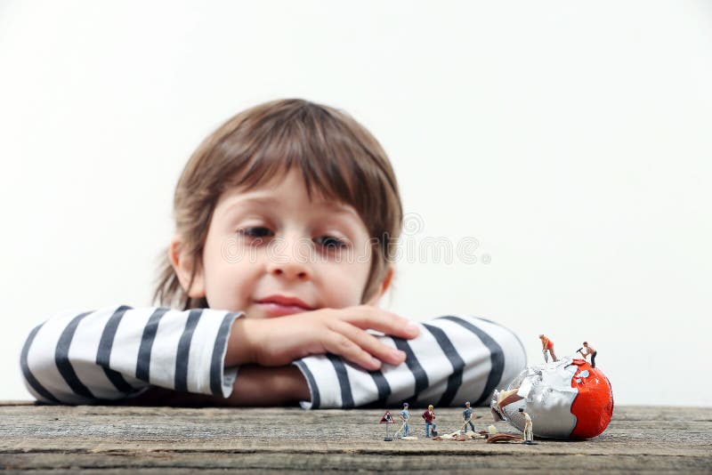 Child Watching Miniature People Breaking an Egg Stock Photo Image of