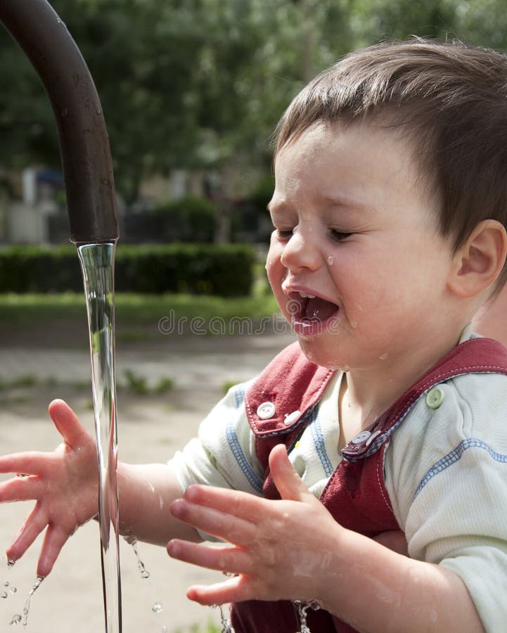Child in water fountain