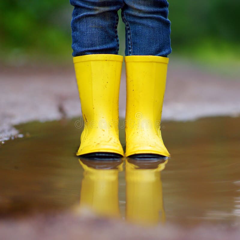 Child Wearing Rain Boots Standing in a Puddle Stock Image Image of