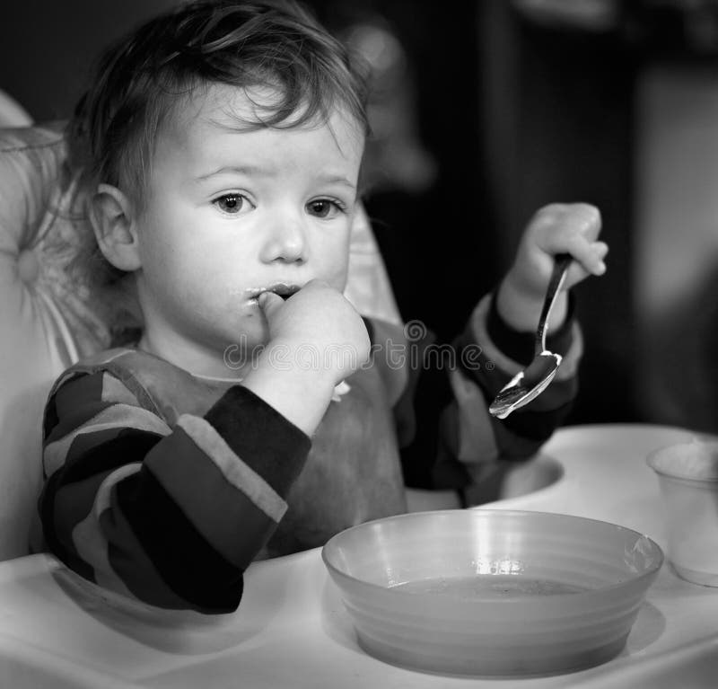 Child Distracted while Eating Stock Photo - Image of child, table: 28471620