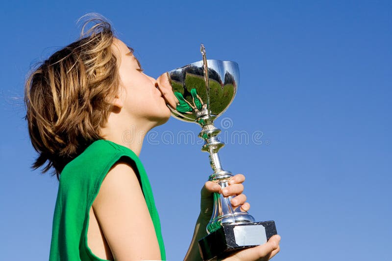 Child winner of trophy or cup royalty free stock photography