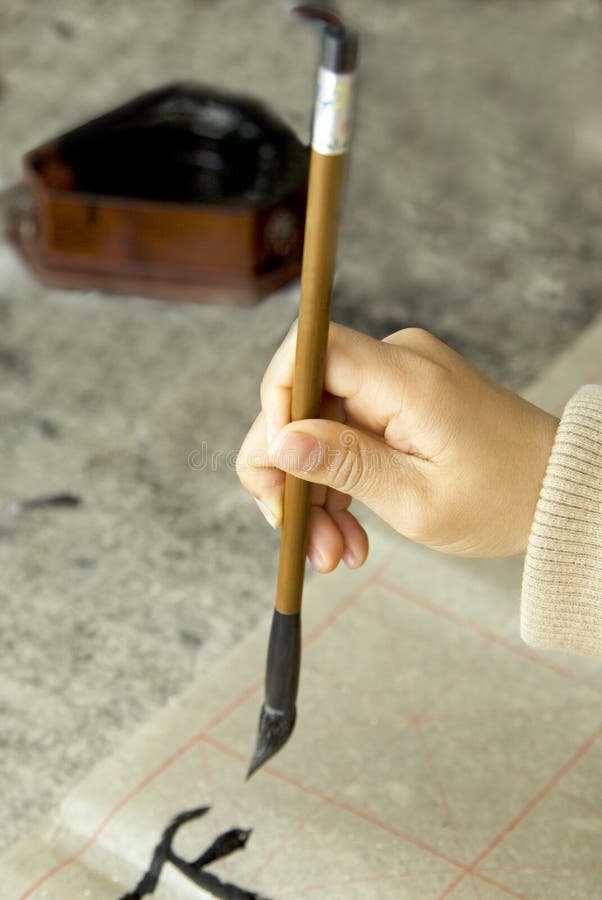 A child writing Chinese Calligraphy