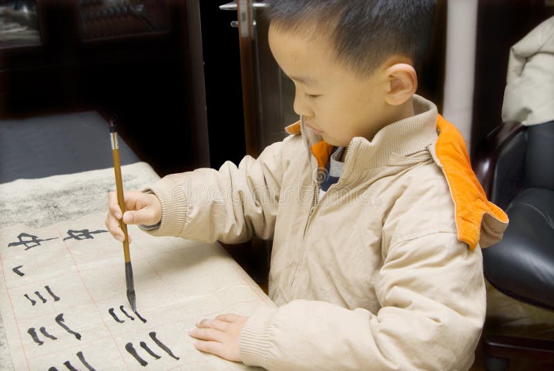 A child writing Chinese Calligraphy stock photo