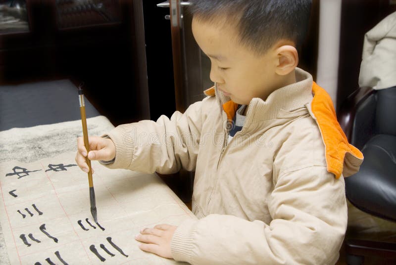 A child writing Chinese Calligraphy