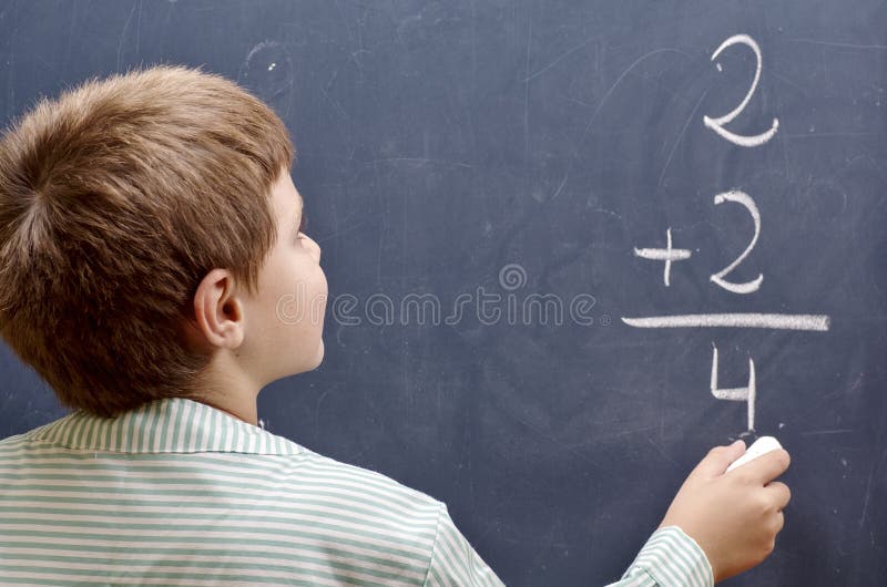 Child writing sum royalty free stock photography