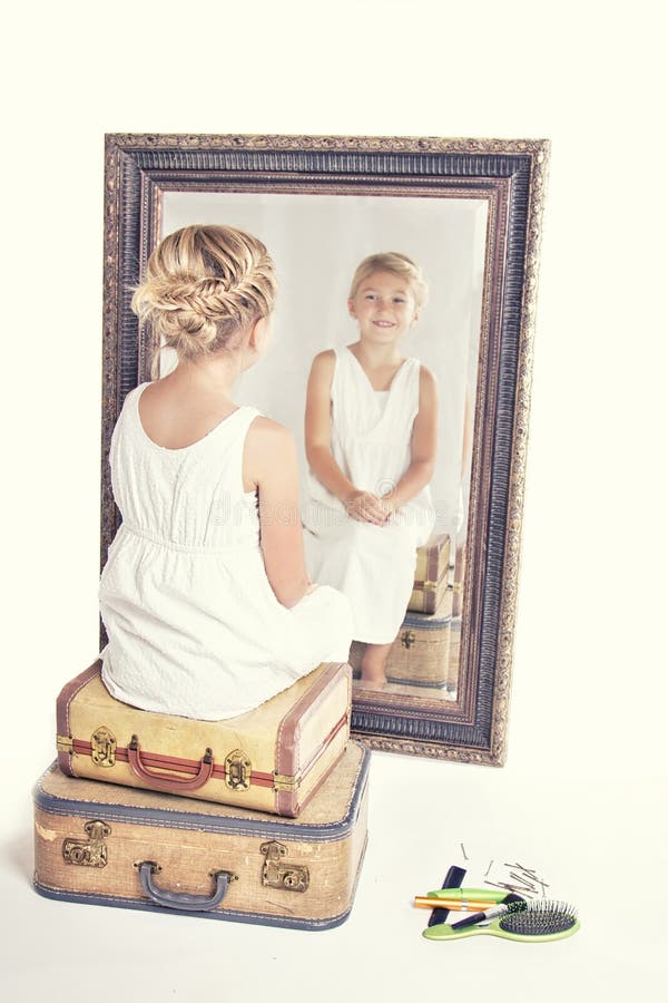 Child or young girl in front of a mirror