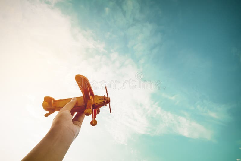 Childhood inspiration - Hands of children holding a toy plane and have dreams wants to be a pilot - Vintage filter effect