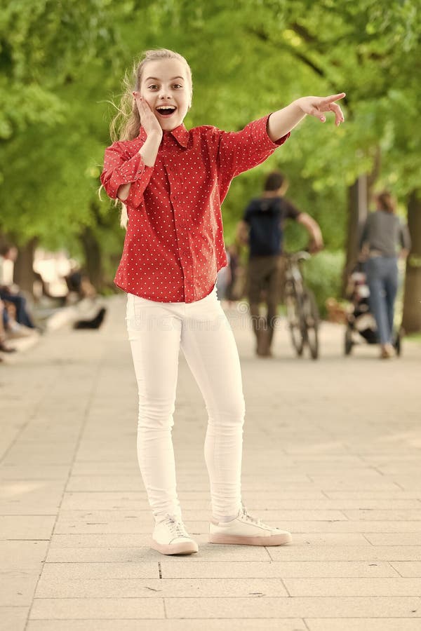 Childhood play and leisure in nature. Happy little child pointing somewhere in casual clothes for playing in park royalty free stock photo Childhood play and leisure in nature. Happy little child pointing somewhere in casual clothes for playing in park royalty free stock photo