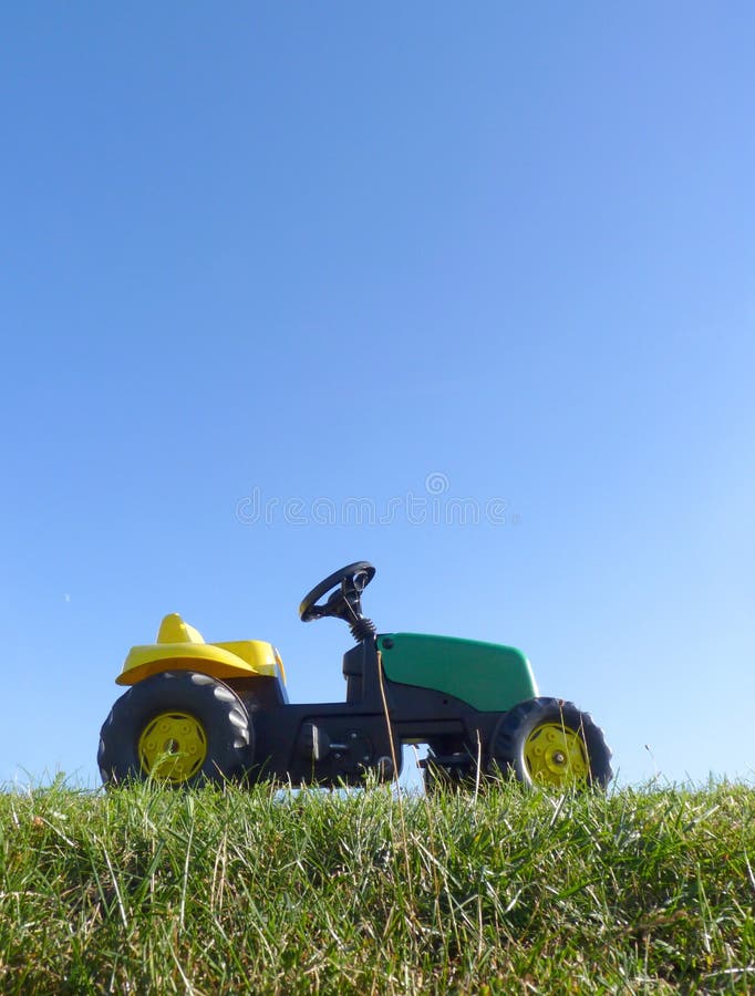 Childhood Toy Pedal Tractor Car stock photo Childhood Toy Pedal Tractor Car stock photo