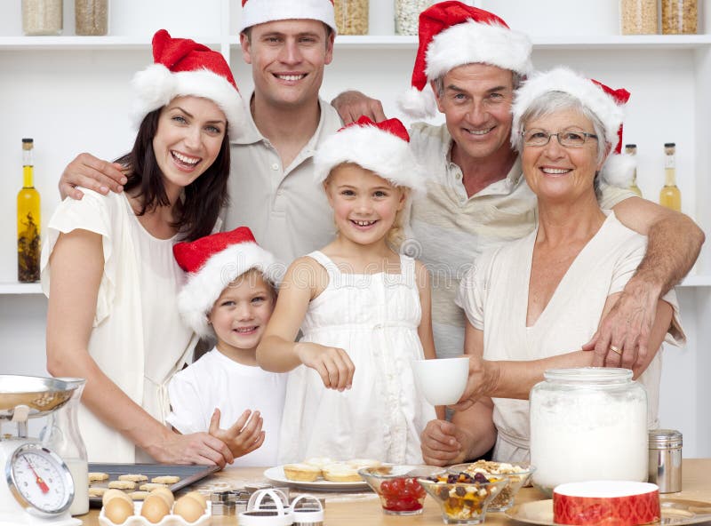 Children baking Christmas cakes with their family