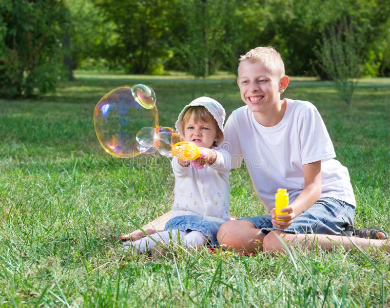 Children blow bubbles stock photo. Image of park, cute - 77508676