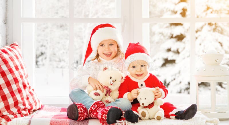 Children brother and sister laughing and sitting on the winter window Christmas stock photography Children brother and sister laughing and sitting on the winter window Christmas stock photography