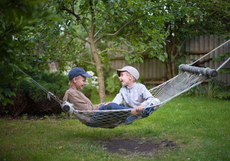 Children brothers talking country garden outdoor