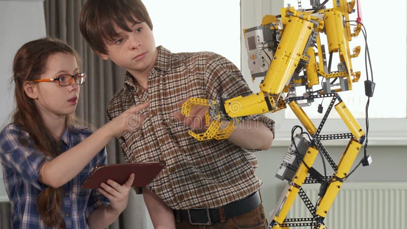 Children check the toy robot stock images Children check the toy robot stock images
