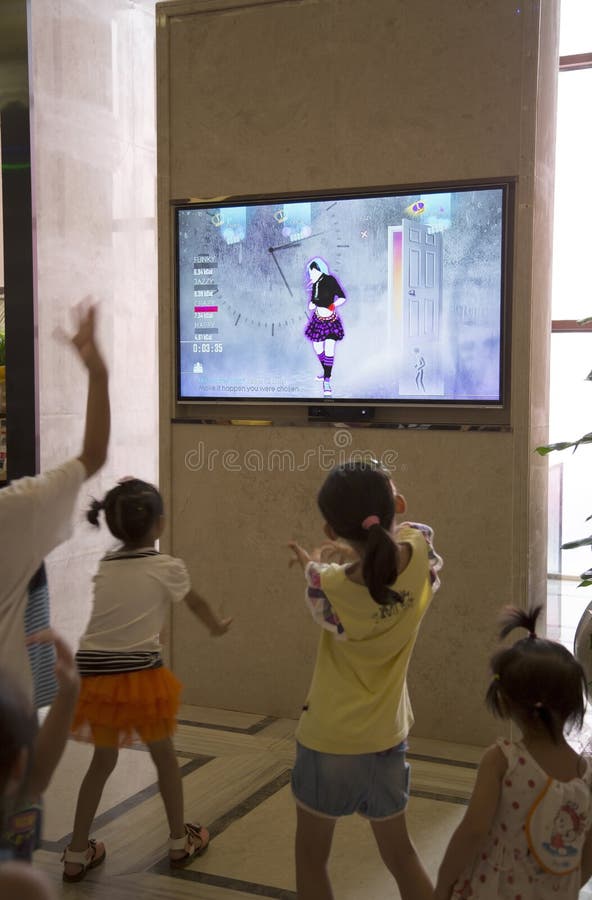 Children dancing while watching TV