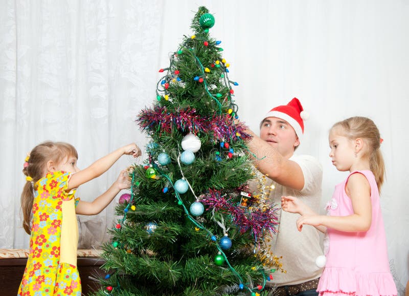 Children decorate the Christmas tree royalty free stock photos