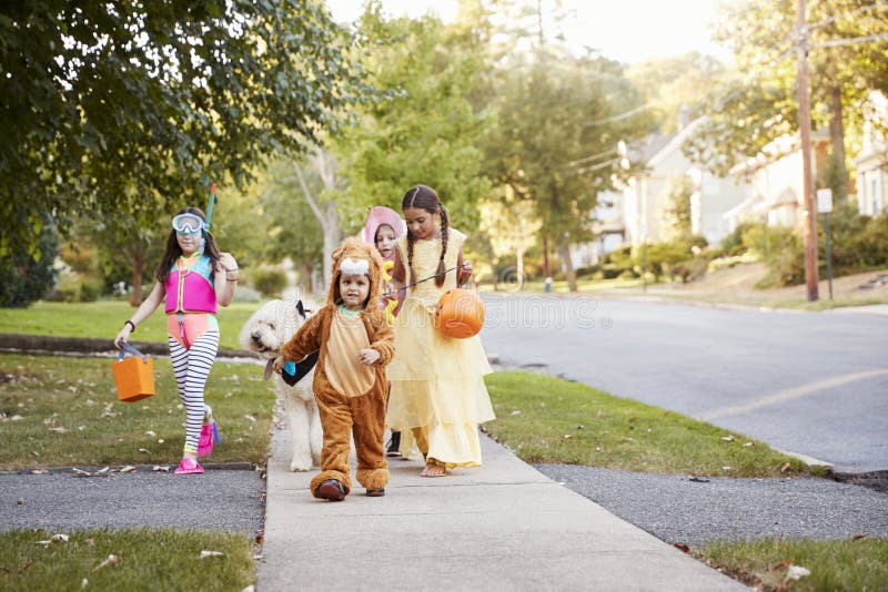 Children And Dog In Halloween Costumes For Trick Or Treating royalty free stock photography Children And Dog In Halloween Costumes For Trick Or Treating royalty free stock photography