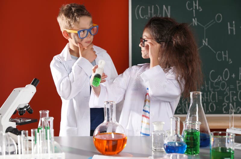 Children doing chemical research in laboratory. Dangerous experiment. Children doing chemical research in laboratory. Dangerous experiment