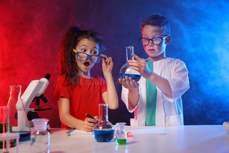 Children doing chemical research in laboratory. Dangerous experiment. Children doing chemical research in laboratory. Dangerous experiment