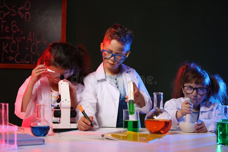 Children doing chemical research in laboratory. Dangerous experiment. Children doing chemical research in laboratory. Dangerous experiment