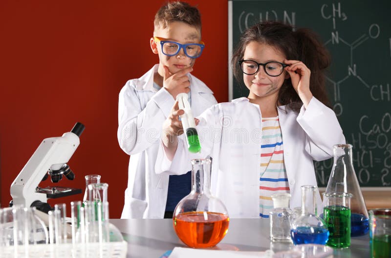 Children doing chemical research in laboratory. Dangerous experiment. Children doing chemical research in laboratory. Dangerous experiment