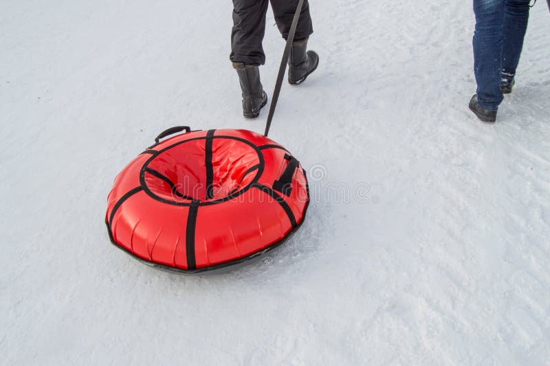 Children dragged sleds tubing to ride a roller coaster in city Park in winter stock images Children dragged sleds tubing to ride a roller coaster in city Park in winter stock images