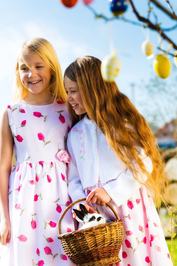 Children on Easter egg hunt with bunny