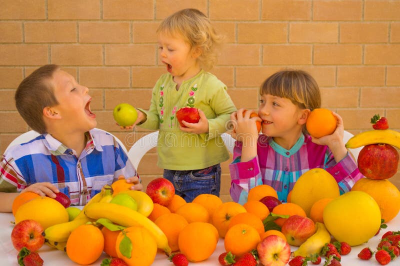 Children eating various lovely fruits. Bananas, oranges, apples, grapefruit, strawberries, pomelo. Children eating various lovely fruits. Bananas, oranges, apples, grapefruit, strawberries, pomelo.