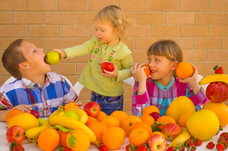 Children eating various lovely fruits. Bananas, oranges, apples, grapefruit, strawberries, pomelo. Children eating various lovely fruits. Bananas, oranges, apples, grapefruit, strawberries, pomelo.