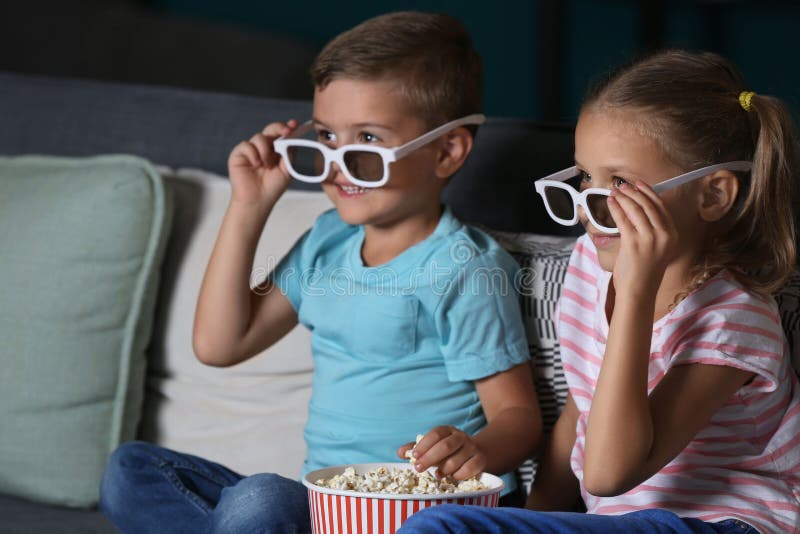 Children Eating Popcorn while Watching TV in Evening Stock Photo ...