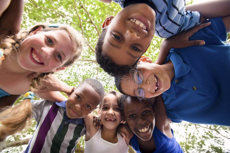 Children embracing in circle around the camera