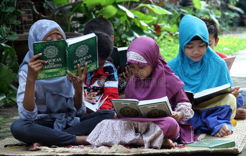 Children fill the school holidays by reading the Qur'an in one of the non-formal education in the city of Solo, Central Java Indon stock photography