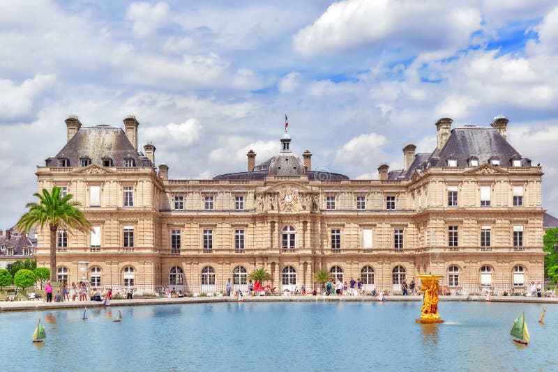 Children float boats in the fountain Luxembourg Palace