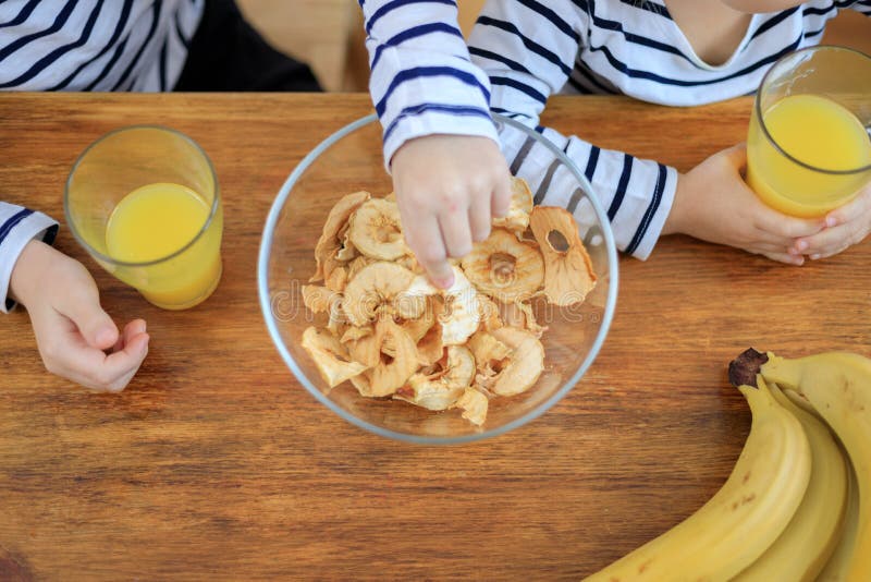 Children with Fruit Chips and Orange Juice Stock Photo Image of girl