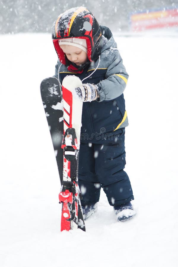 Children fun activity ski resort winter outfit. Children fun activity at a ski resort in winter in outfit royalty free stock image Children fun activity ski resort winter outfit. Children fun activity at a ski resort in winter in outfit royalty free stock image
