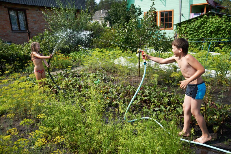 Children with garden hoses