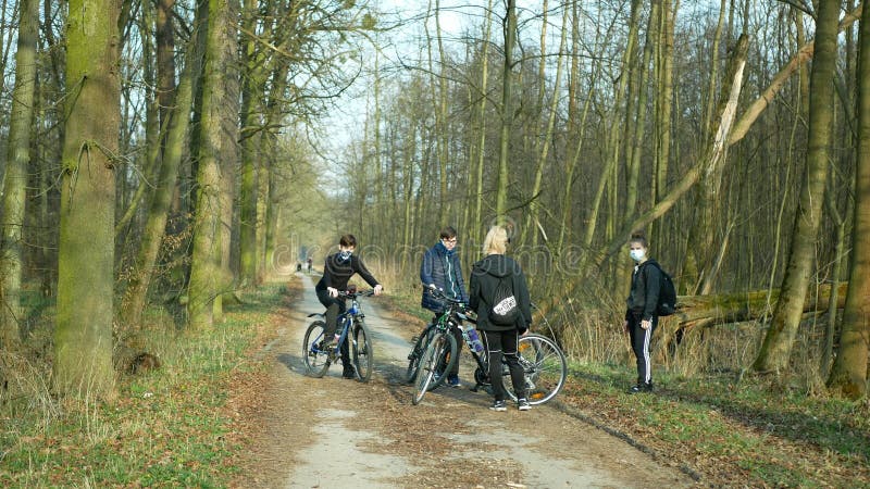 OLOMOUC, CZECH REPUBLIC, MARCH 19, 2020: Children girls boys group on trip bikes wood nature violate Government law