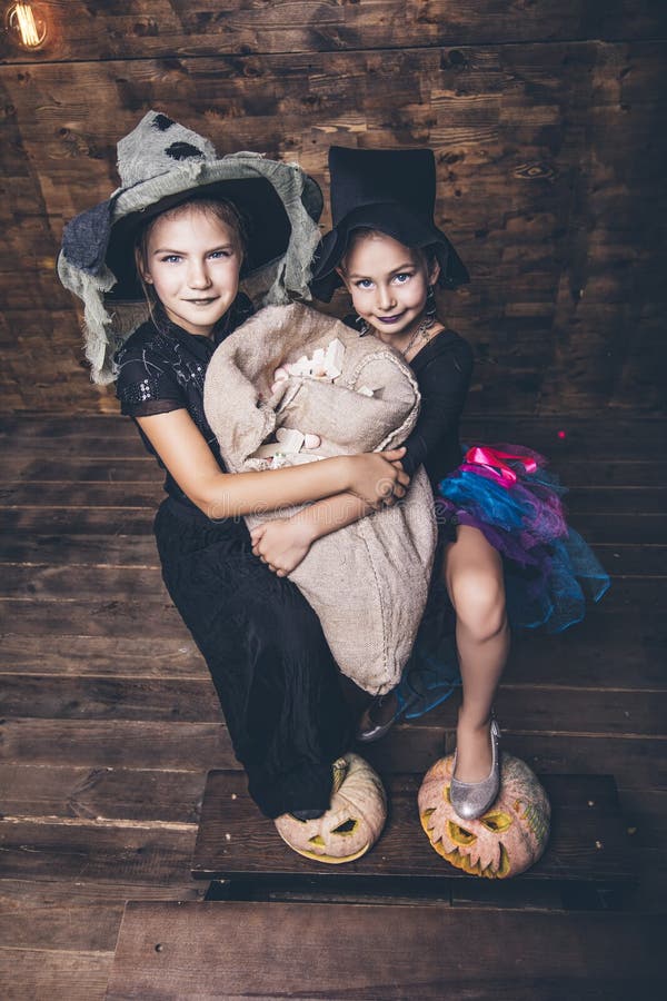 Children Girls Costumes Witches with Pumpkins and Treats in the Stock ...