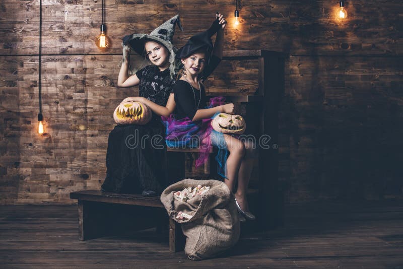 Children Girls Costumes Witches with Pumpkins and Treats in the Stock ...